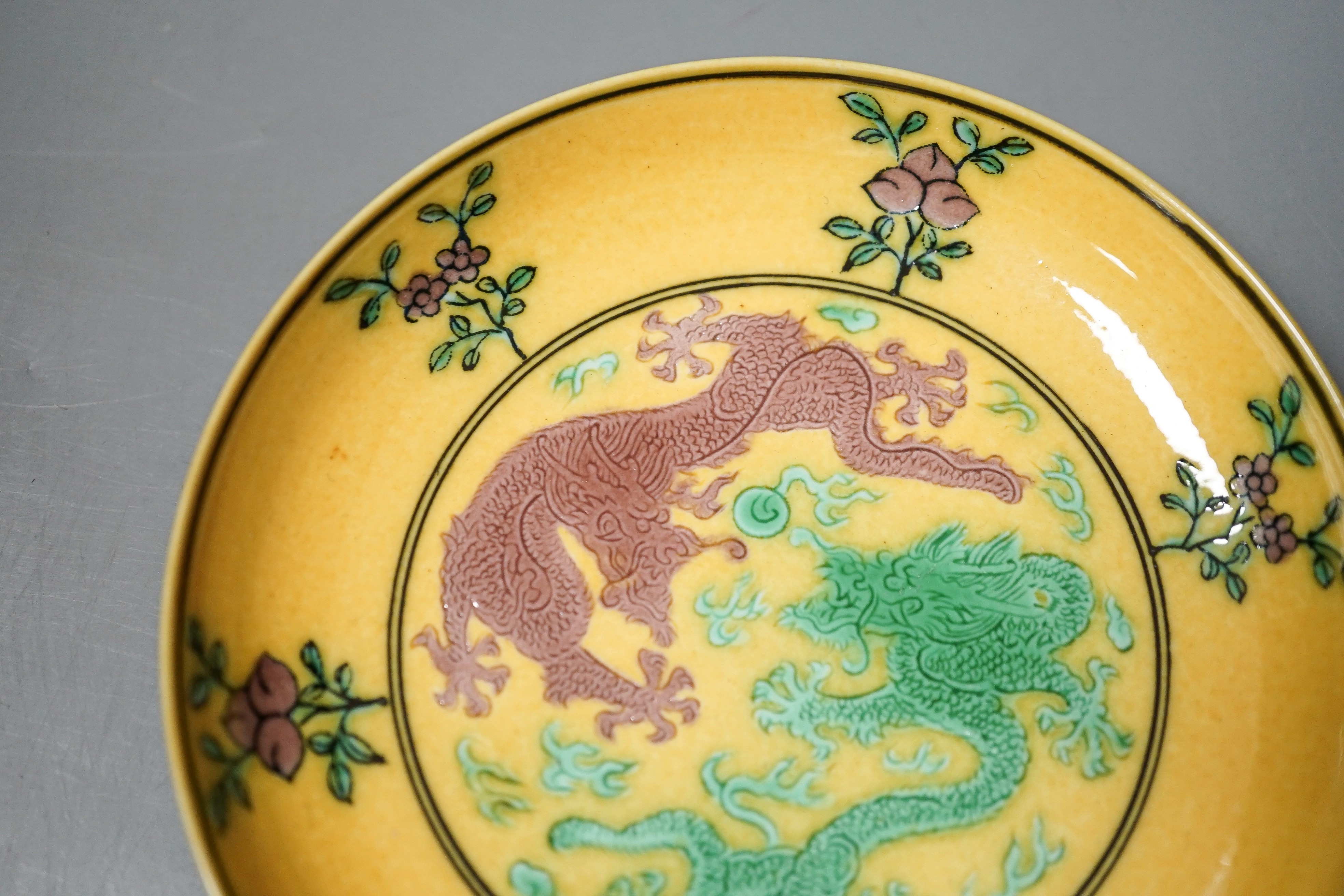 A Chinese yellow ground green and aubergine enamelled 'dragon' dish, Guangxu mark and possibly of the period, D.11cm